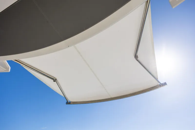 Slide: The Image of Tiara Yachts 43 LE 2022 model awning against clear blue sky. - 67