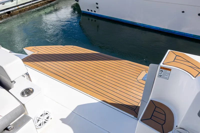 Slide: The Image of 2022 Tiara Yachts 43 LE swim platform with teak decking, docked in marina. - 74