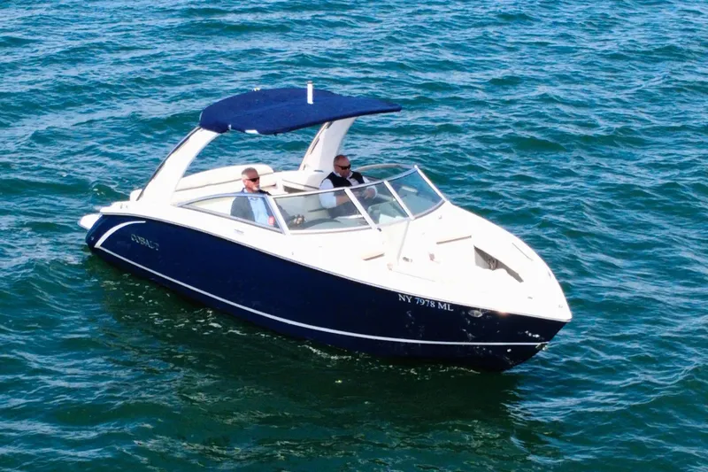 The Image of 2016 Cobalt R5 boat cruising on blue water with two passengers. - 1