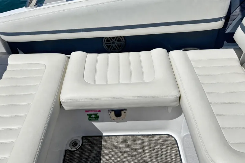 Slide: The Image of 2016 Cobalt R5 boat interior with white cushioned seating and marine speaker. - 13