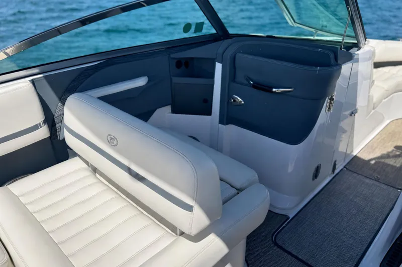 Slide: The Image of Interior of a 2016 Cobalt R5 boat with white seating and blue accents. - 14