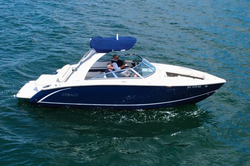 Slide: The Image of 2016 Cobalt R5 boat cruising on open water with passengers onboard. - 3