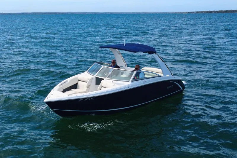 Slide: The Image of 2016 Cobalt R5 boat cruising on open water under clear blue skies. - 4