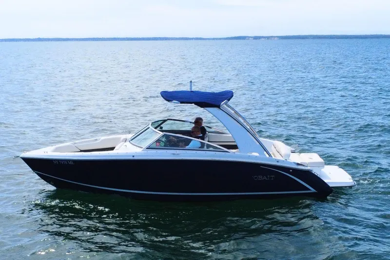 Slide: The Image of 2016 Cobalt R5 boat cruising on open water with blue canopy. - 5