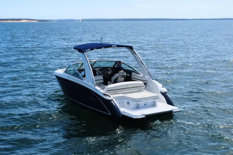 Slide: The Image of 2016 Cobalt R5 boat cruising on open water under clear skies. - 6