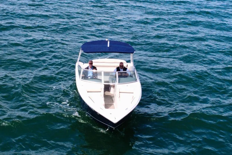 Slide: The Image of 2016 Cobalt R5 boat cruising on open water with two passengers. - 7