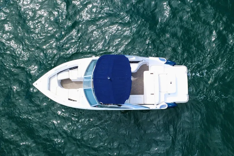 Slide: The Image of Aerial view of 2016 Cobalt R5 boat with blue canopy on open water. - 9