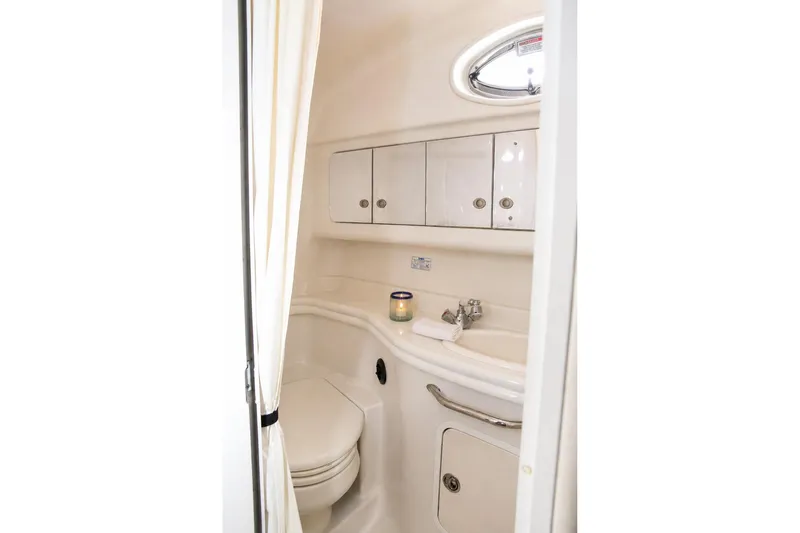 Slide: The Image of Bathroom interior of 2006 Sea Ray 340 Sundancer yacht, featuring sink and storage cabinets. - 10