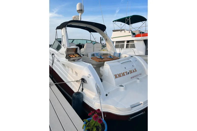 Slide: The Image of 2006 Sea Ray 340 Sundancer docked, featuring a grill and outdoor seating area. - 4
