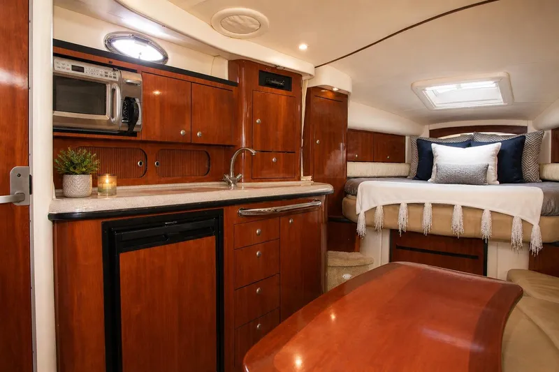 Slide: The Image of Interior of 2006 Sea Ray 340 Sundancer yacht with cozy cabin and kitchenette. - 6
