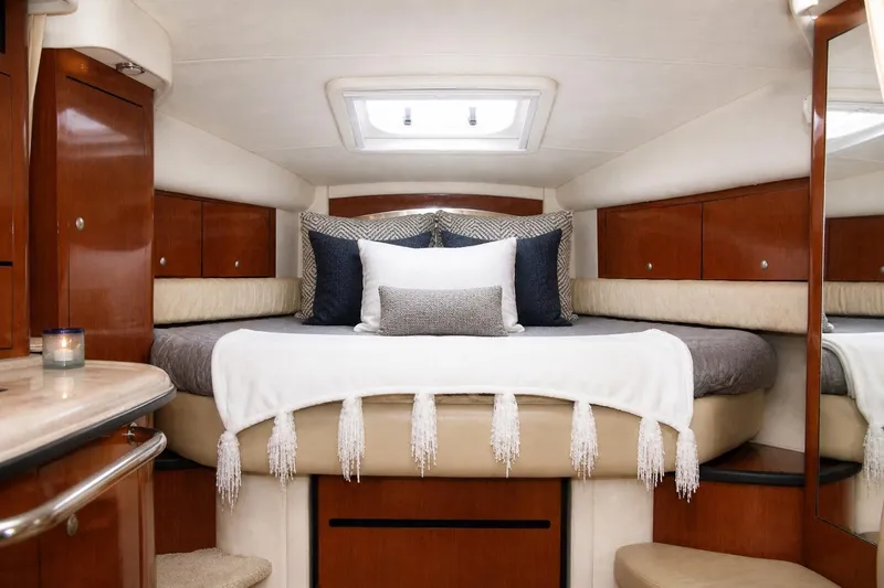 Slide: The Image of Luxurious interior of 2006 Sea Ray 340 Sundancer yacht with cozy bed and elegant decor. - 9