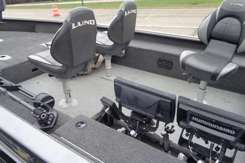 Slide: The Image of Interior of a 2011 Lund 2010 Pro Guide boat with seats and Humminbird electronics. - 10