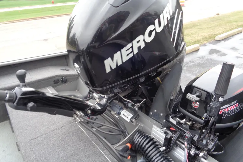 Slide: The Image of 2011 Lund Pro Guide boat with Mercury outboard motor, parked on pavement. - 15