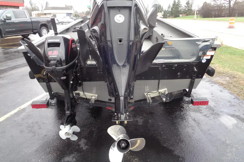 Slide: The Image of Rear view of a 2011 Lund 2010 Pro Guide boat with Mercury outboard motor. - 16