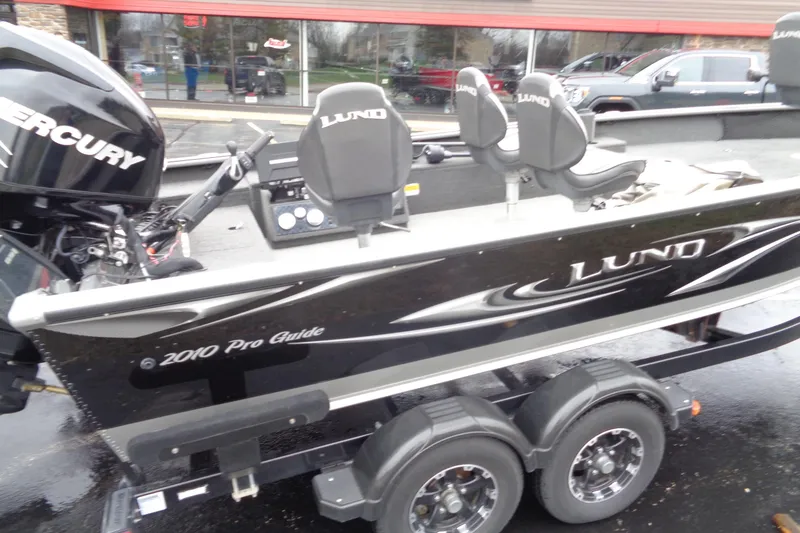 Slide: The Image of Lund 2010 Pro Guide boat with Mercury engine, parked on a trailer, 2011 model. - 20