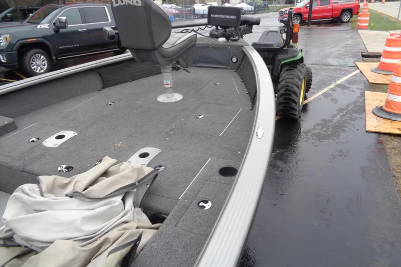 Slide: The Image of 2011 Lund 2010 Pro Guide boat with seating, parked near construction cones. - 22