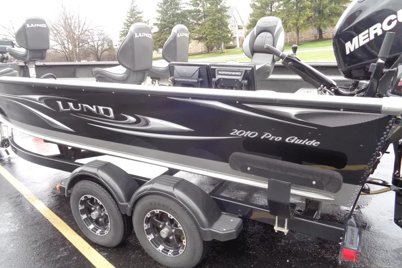 Slide: The Image of Lund 2010 Pro Guide boat on trailer, featuring Mercury engine and Humminbird electronics. - 5