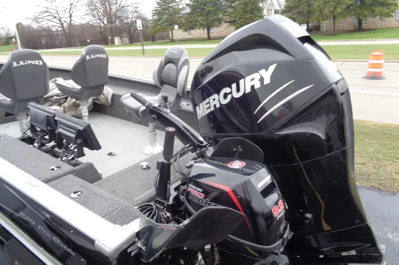 Slide: The Image of 2011 Lund 2010 Pro Guide boat with Mercury outboard motor, featuring comfortable seating. - 6