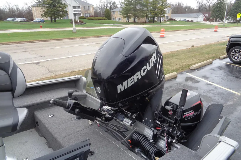 Slide: The Image of Lund 2010 Pro Guide boat with Mercury outboard motor, parked in a lot. - 8