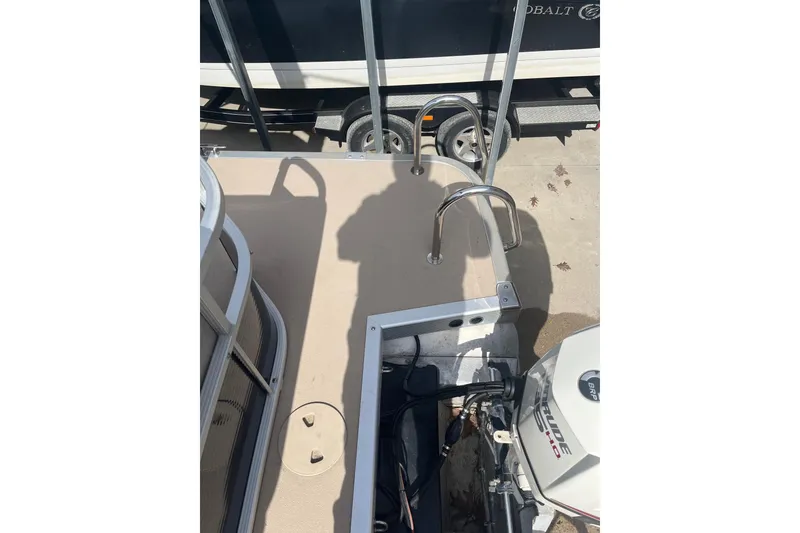 Slide: The Image of 2014 Bennington 22 SLX boat with motor and ladder, parked on a trailer. - 5