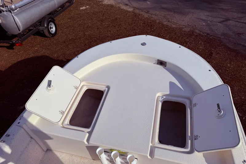 Slide: The Image of 2019 Carolina Skiff 18 JVX CC boat deck with open storage compartments. - 12