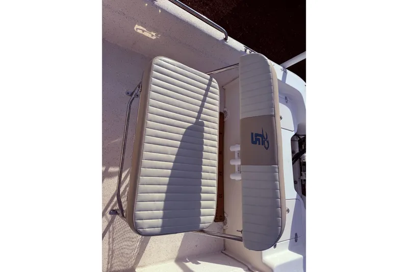 Slide: The Image of 2019 Carolina Skiff 18 JVX CC boat seat with gray upholstery and storage compartment. - 14