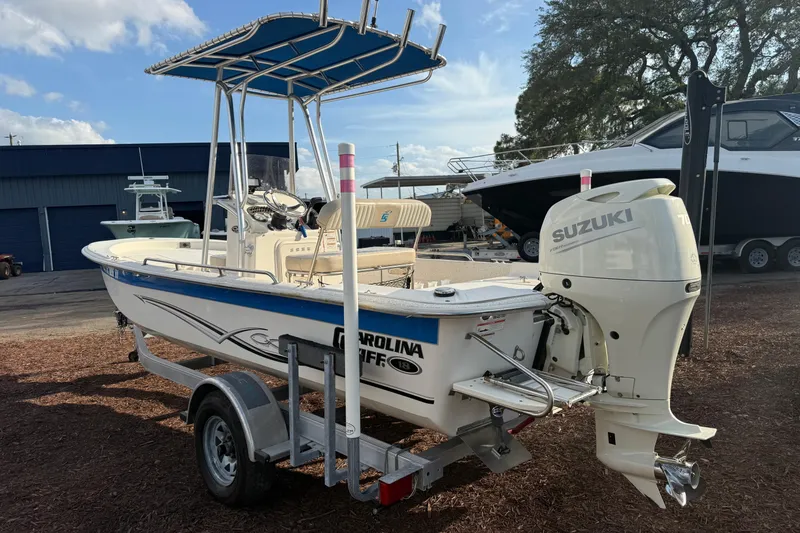 Slide: The Image of 2019 Carolina Skiff 18 JVX CC boat with Suzuki outboard motor on trailer. - 3