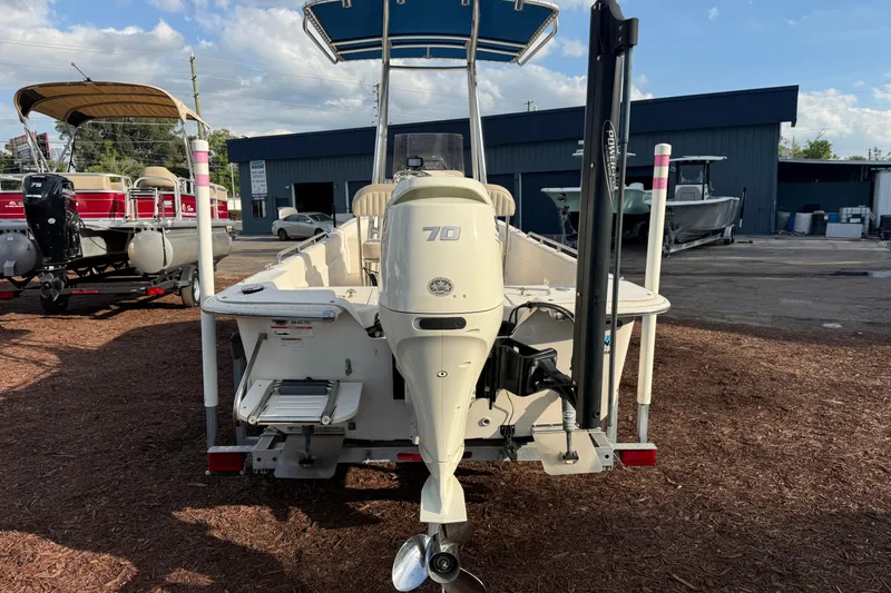 Slide: The Image of 2019 Carolina Skiff 18 JVX CC boat with outboard motor, parked outdoors. - 4