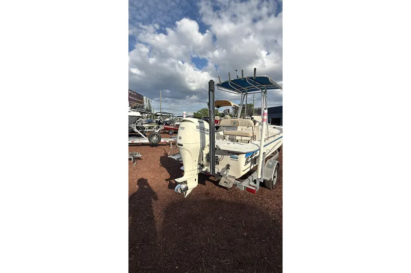 Slide: The Image of 2019 Carolina Skiff 18 JVX CC boat with Suzuki outboard motor on trailer under cloudy sky. - 5