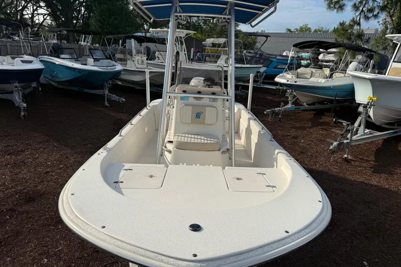 Slide: The Image of 2019 Carolina Skiff 18 JVX CC boat displayed among other boats in a lot. - 9