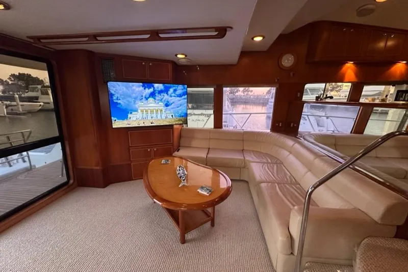 Slide: The Image of Luxurious interior of a 1999 Mikelson 64 Long Range Sportfish yacht with plush seating and large TV. - 10