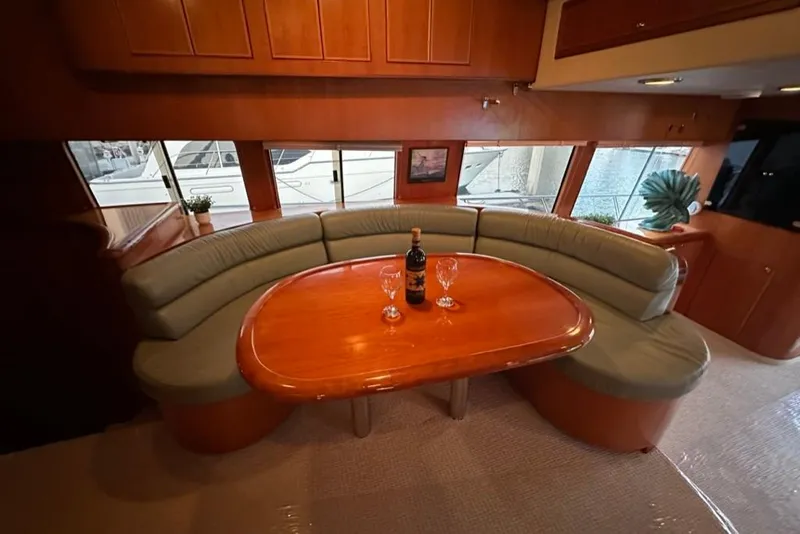 Slide: The Image of Luxurious interior of a 1999 Mikelson 64 yacht with elegant dining area and wine setup. - 12