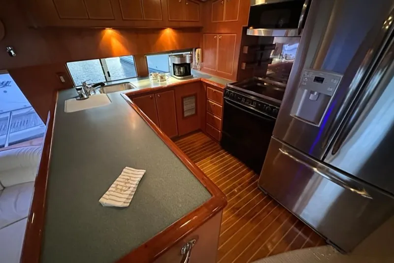 Slide: The Image of Luxurious kitchen interior of a 1999 Mikelson 64 Long Range Sportfish yacht. - 15