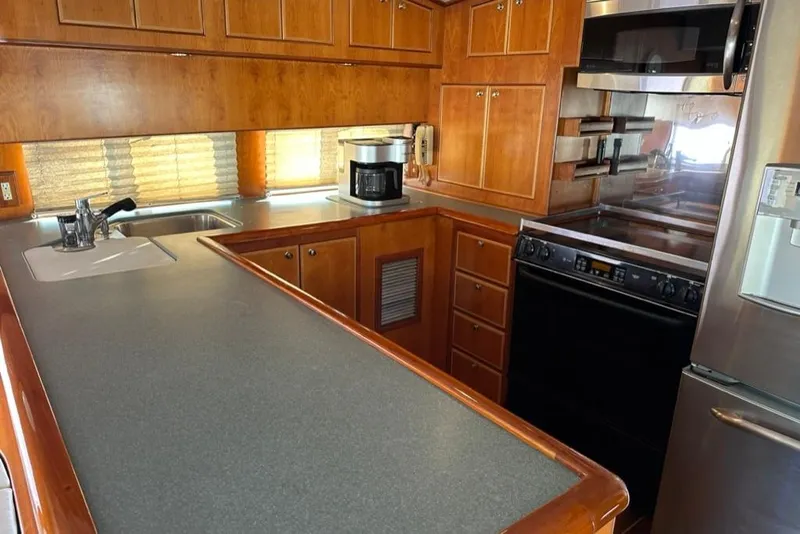 Slide: The Image of Luxurious kitchen interior of 1999 Mikelson 64 Long Range Sportfish yacht. - 16