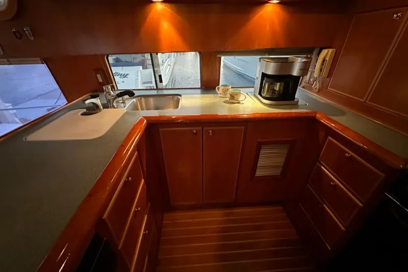 Slide: The Image of Luxurious wooden kitchen interior of a 1999 Mikelson 64 Long Range Sportfish yacht. - 18