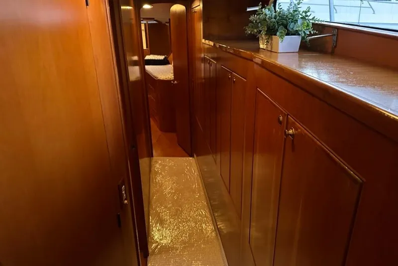 Slide: The Image of Luxurious wooden interior hallway of a 1999 Mikelson 64 Long Range Luxury Sportfish yacht. - 19