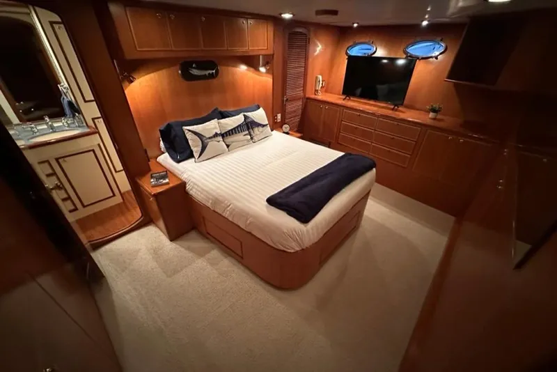 Slide: The Image of Luxurious bedroom interior of a 1999 Mikelson 64 Long Range Luxury Sportfish yacht. - 20