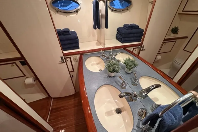 Slide: The Image of Luxurious bathroom in 1999 Mikelson 64 Long Range Sportfish yacht with dual sinks and elegant decor. - 26