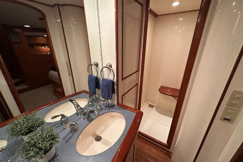 Slide: The Image of Luxurious bathroom in 1999 Mikelson 64 Long Range Sportfish yacht with dual sinks and shower. - 27