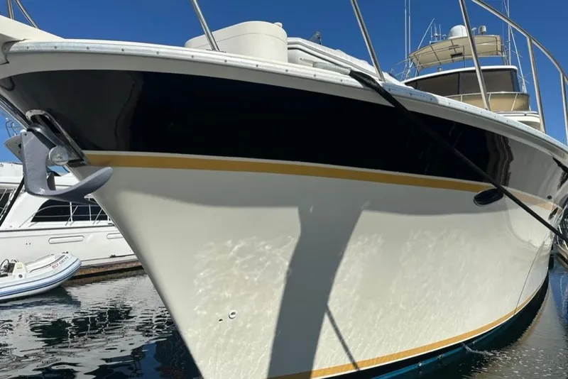 Slide: The Image of 1999 Mikelson 64 Long Range Luxury Sportfish yacht docked, showcasing sleek design and elegant lines. - 3