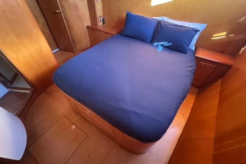 Slide: The Image of Luxurious cabin interior of a 1999 Mikelson 64 Long Range Sportfish yacht with a cozy bed. - 30