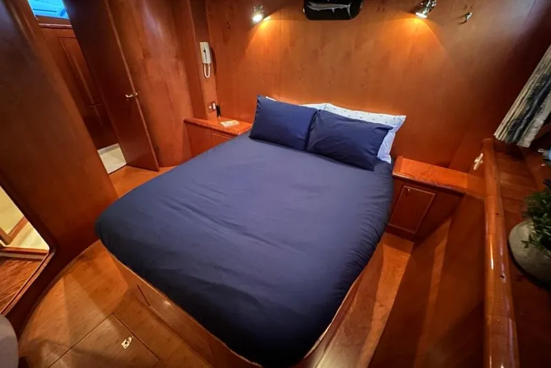 Slide: The Image of Luxurious cabin interior of 1999 Mikelson 64 Long Range Sportfish yacht with cozy bed. - 35