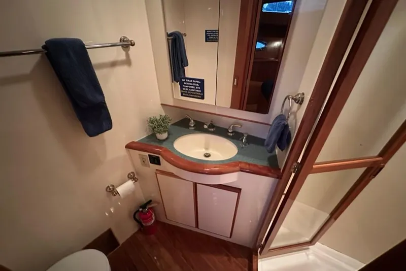 Slide: The Image of Bathroom interior of 1999 Mikelson 64 Long Range Luxury Sportfish yacht. - 36