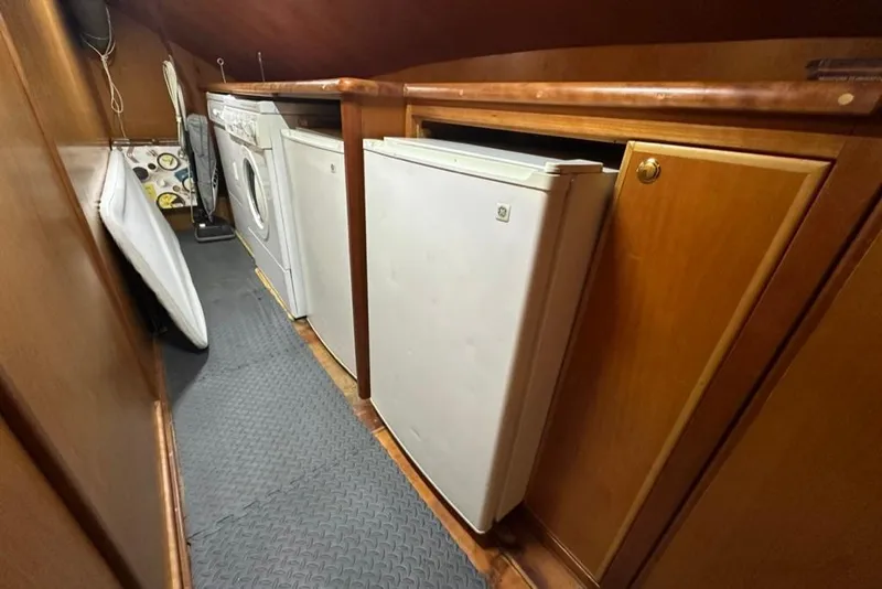 Slide: The Image of Laundry and storage area inside a 1999 Mikelson 64 Long Range Luxury Sportfish yacht. - 45