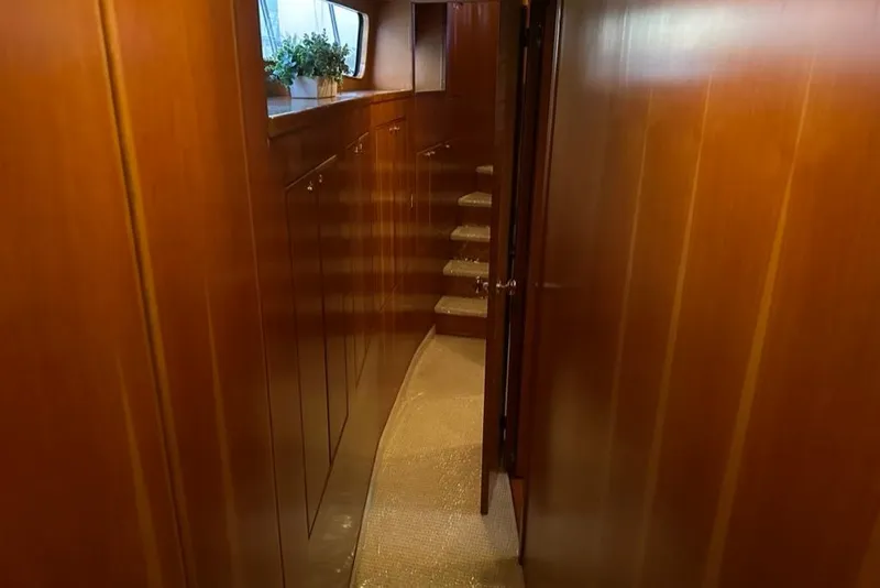 Slide: The Image of Interior hallway of 1999 Mikelson 64 Long Range Luxury Sportfish yacht with wooden paneling. - 46