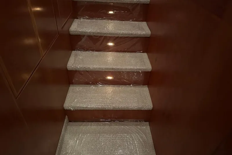 Slide: The Image of Carpeted stairs inside a 1999 Mikelson 64 Long Range Luxury Sportfish yacht. - 47