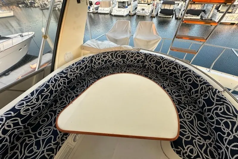 Slide: The Image of Luxury seating area on 1999 Mikelson 64 Long Range Sportfish yacht, overlooking marina. - 48