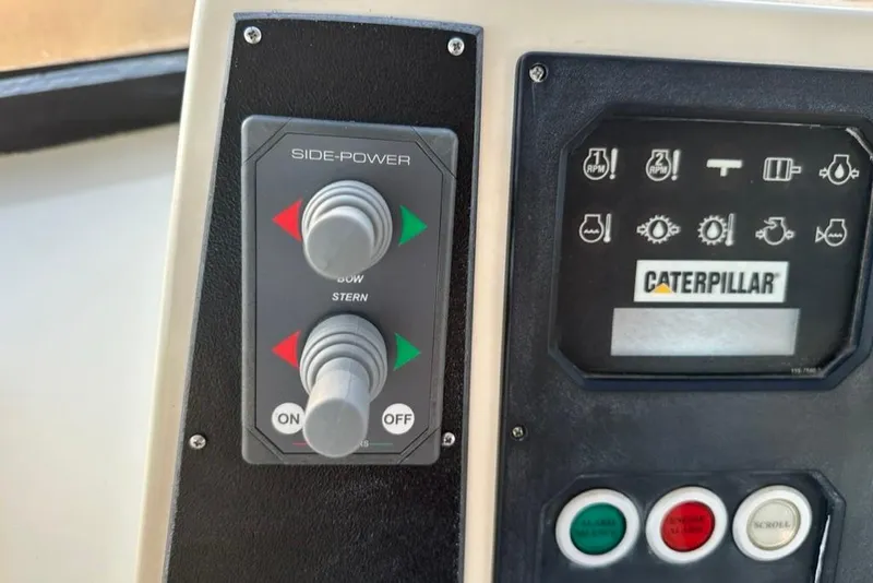 Slide: The Image of Control panel of a 1999 Mikelson 64 Long Range Luxury Sportfish with Side-Power and Caterpillar systems. - 52