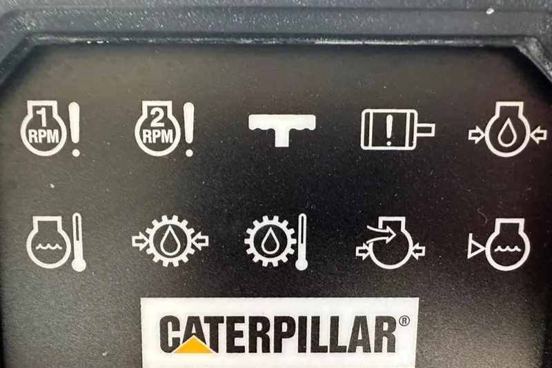 Slide: The Image of Control panel with Caterpillar logo and various engine warning icons. Mikelson 64 Long Range Luxury Sportfish, 1999. - 53