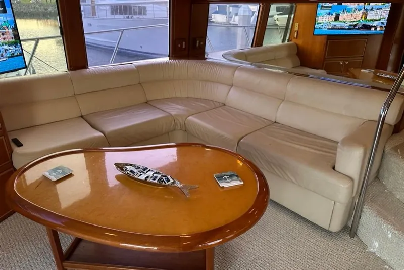 Slide: The Image of Luxurious interior of a 1999 Mikelson 64 yacht with plush seating and elegant decor. - 6